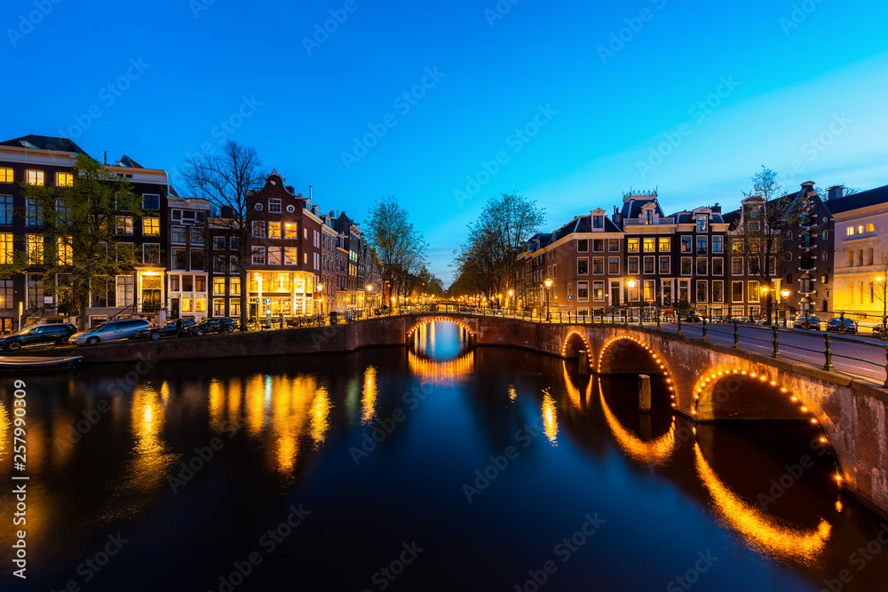 City view of Amsterdam, the Netherlands with Amstel river at night.