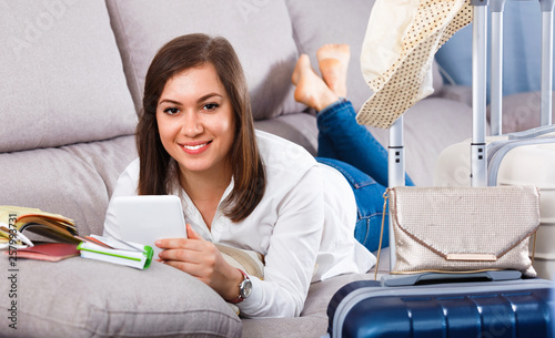 Woman booking online for holidays at home