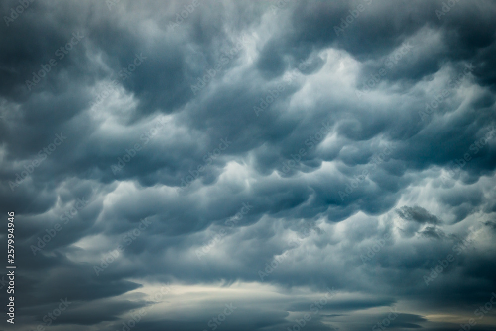 Stormy rain clouds background. Dark sky. Dramatic Moody Thunder Storm. Climate Change weather environment background.