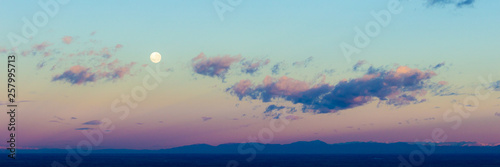 Dawn sunrise pink clouds in sky with full moon background. Beautiful skies. S...
