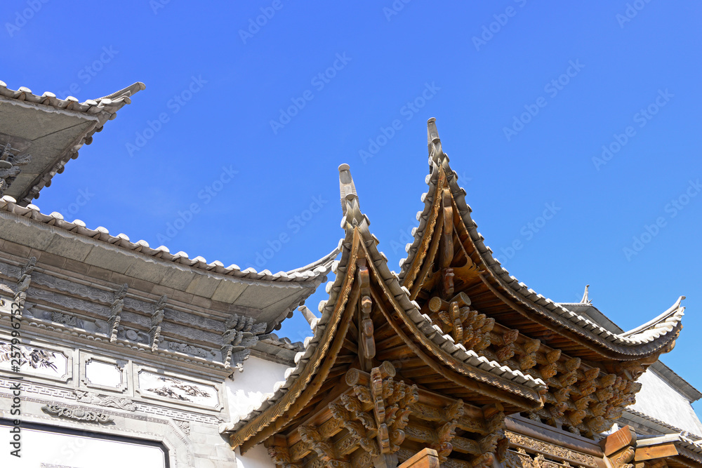 The corner of the ancient building against the blue sky The corner of the ancient building against the blue sky
