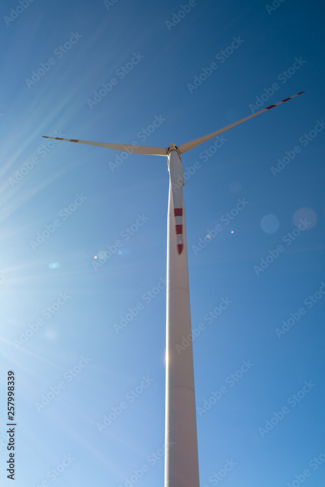 Field with windmills for electric power. Clean energy produced by the wind. Extraction of energy from the air Field with windmills for electric power. Clean energy produced by the wind. Extraction of energy from the air