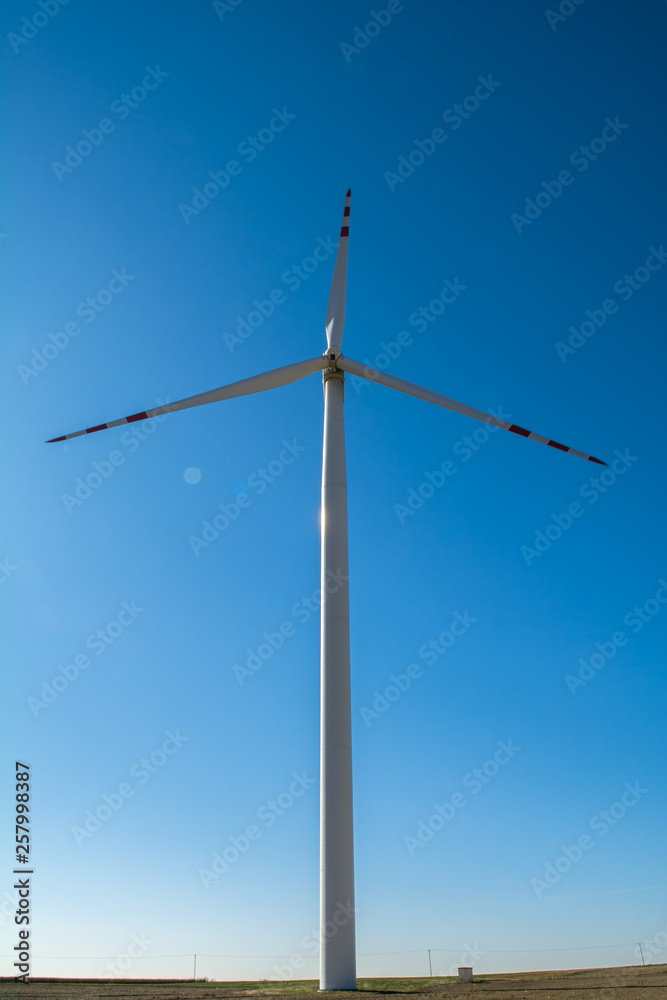 Field with windmills for electric power. Clean energy produced by the wind. Extraction of energy from the air Field with windmills for electric power. Clean energy produced by the wind. Extraction of energy from the air