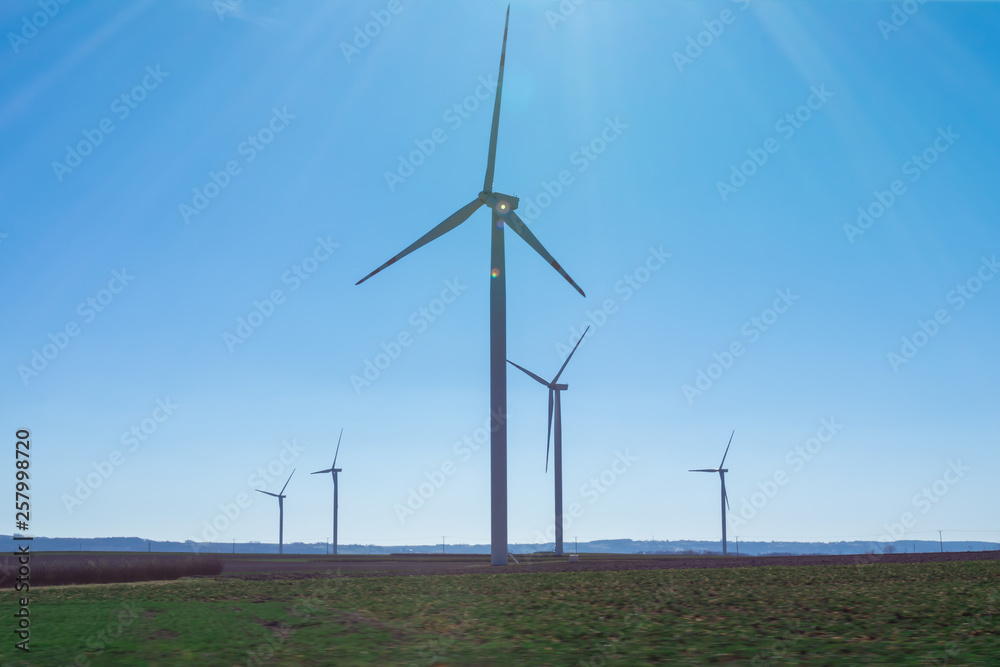 Field with windmills for electric power. Clean energy produced by the wind. Extraction of energy from the air Field with windmills for electric power. Clean energy produced by the wind. Extraction of energy from the air