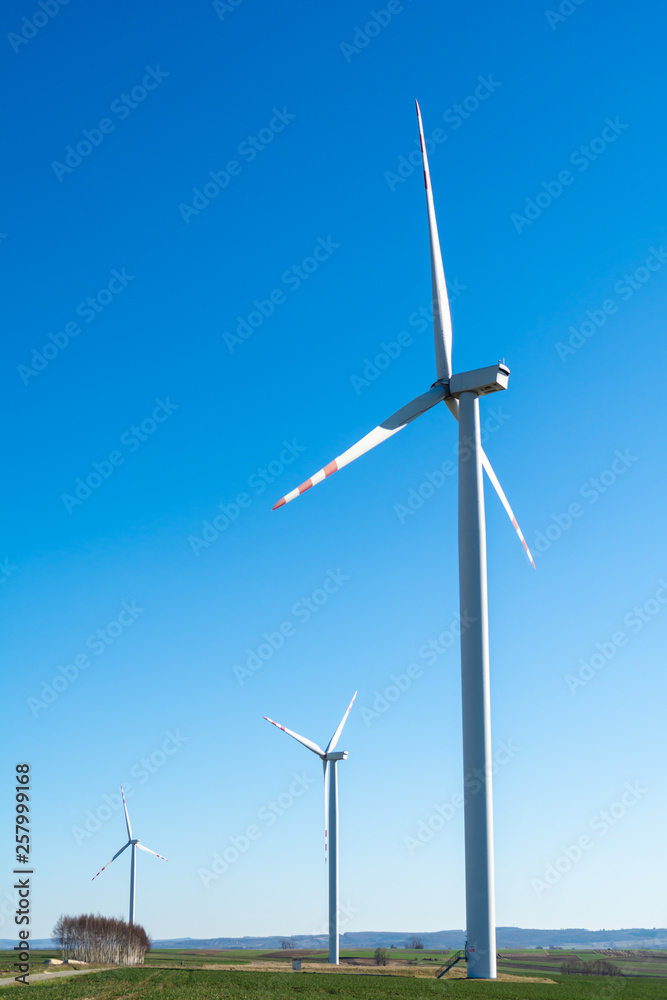 Field with windmills for electric power. Clean energy produced by the wind. Extraction of energy from the air Field with windmills for electric power. Clean energy produced by the wind. Extraction of energy from the air