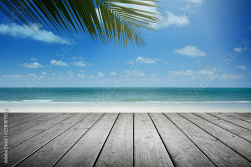 Beach background with palm tree and empty wooden  Summer.