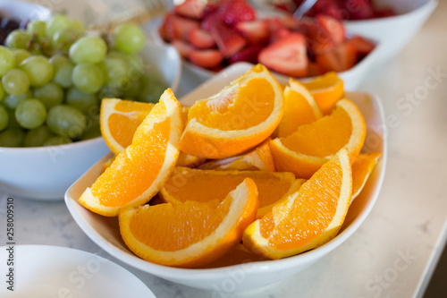 Sliced Oranges and fresh strawberries and green grapes