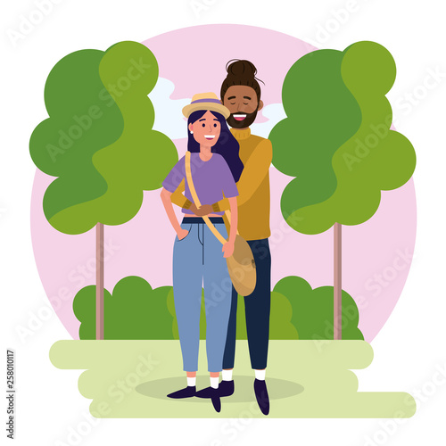 woman and man couple with trees and bushes