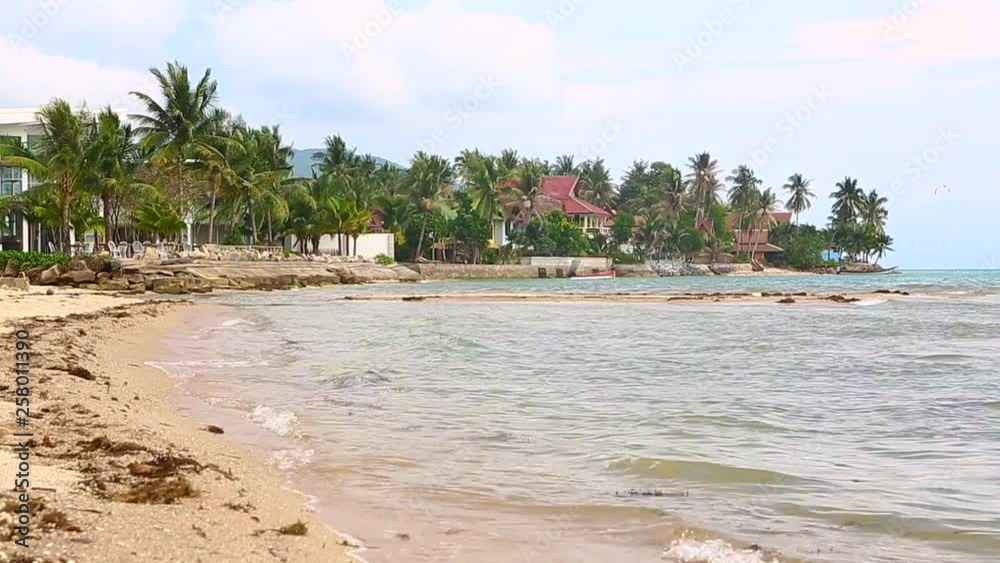 Tropical island with sandy beach and dea waves in windy weather Tropical island with sandy beach and dea waves in windy weather