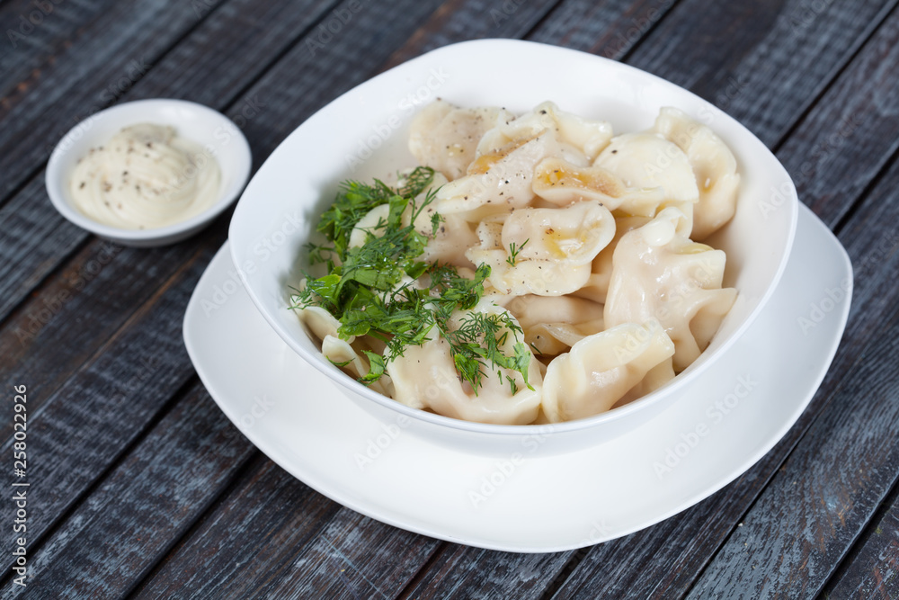 real, delicious, Russian dumplings on the table, with fresh herbs and spices, for cooking design. real, delicious, Russian dumplings on the table, with fresh herbs and spices, for cooking design.