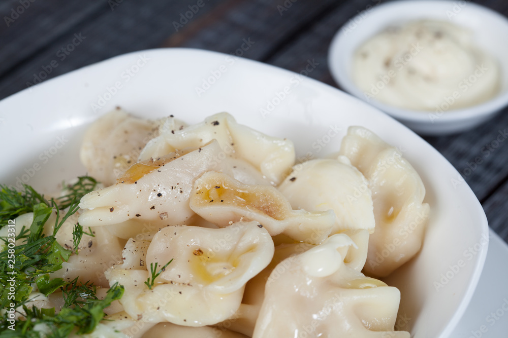 real, delicious, Russian dumplings on the table, with fresh herbs and spices, for cooking design. real, delicious, Russian dumplings on the table, with fresh herbs and spices, for cooking design.