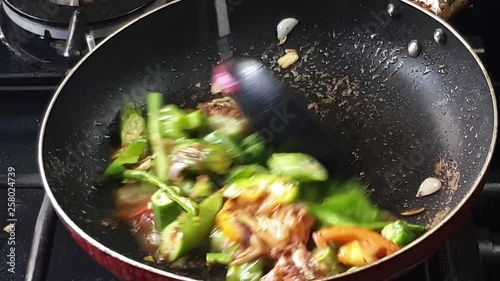close up shot of delicious asian veggies being cook in high heat and serve in plate photo