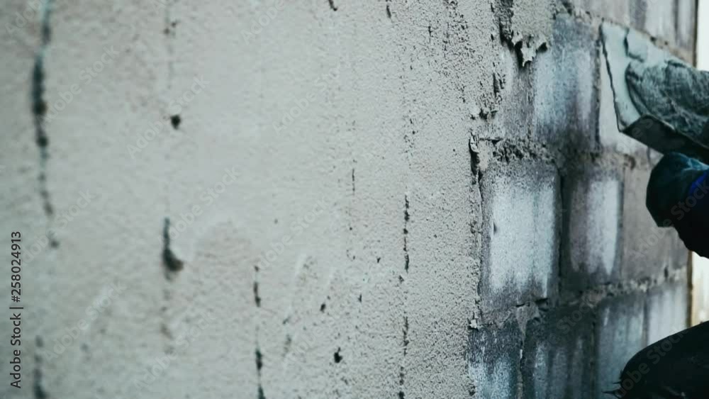 Hand of man plastering concrete build a wall.