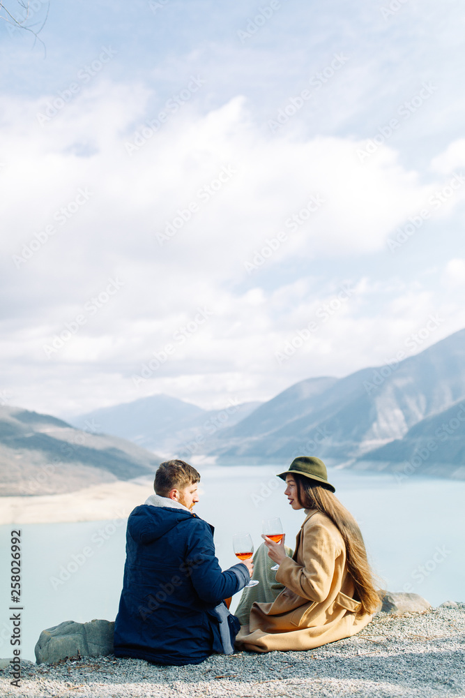 A beautiful couple travels in the mountains of Georgia. Lovestory in nature with a lake. A beautiful couple travels in the mountains of Georgia. Lovestory in nature with a lake.