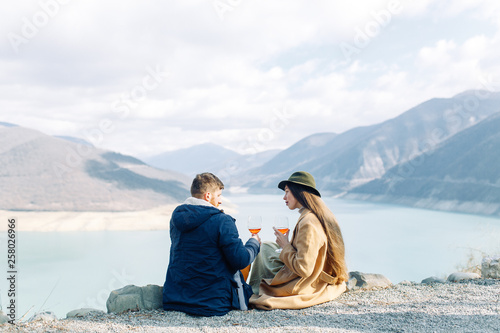 A beautiful couple travels in the mountains of Georgia. Lovestory in nature with a lake. © pavelvozmischev