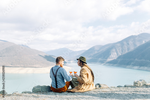 A beautiful couple travels in the mountains of Georgia. Lovestory in nature with a lake.