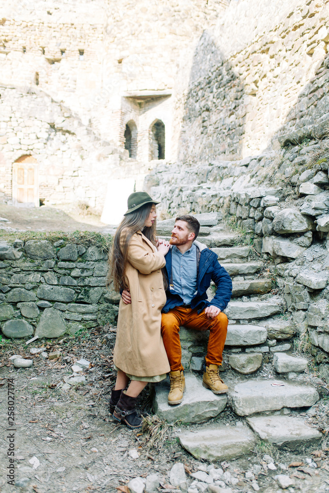 A beautiful couple travels to the sights of Georgia. Love story in nature with the fortress.