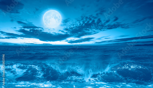Night sky with moon in the clouds with dark sea  Elements of this image furnished by NASA