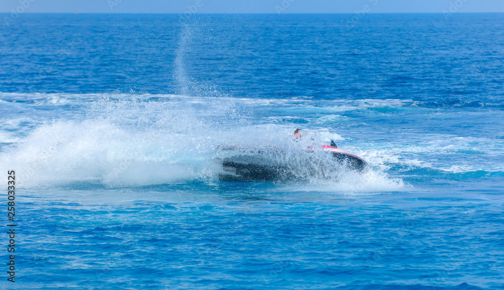 Obraz premium Man on jet ski jump on the wave