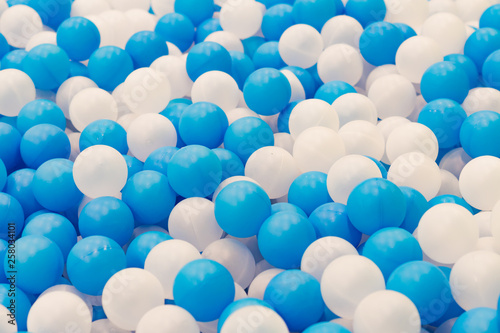 Close up of plastic white and blue balls in dry pool on the playground