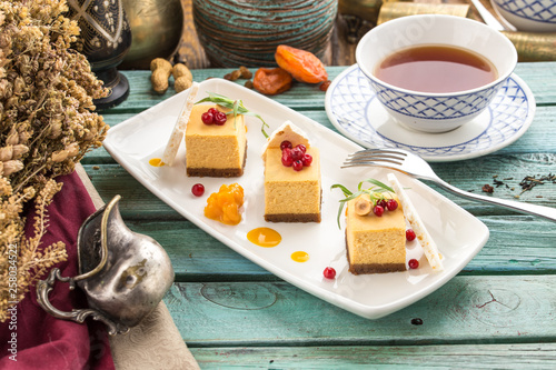Canvastavla Square Earl Gray Rare Cheesecake With red berries and Cup of tea on blue wooden