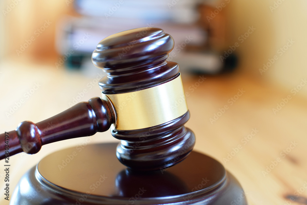 Judges gavel or law mallet and sound block on wooden working table, close-up. Judgement or auction, justice and judgements concept. Judges gavel or law mallet and sound block on wooden working table, close-up. Judgement or auction, justice and judgements concept.