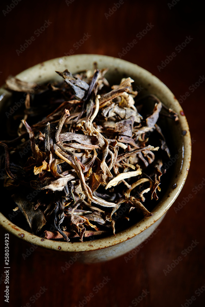 Dried tea leaves in cup 