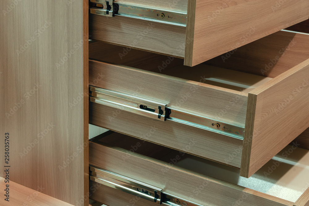 Wooden facades on the drawers close-up, cabinet furniture Wooden facades on the drawers close-up, cabinet furniture