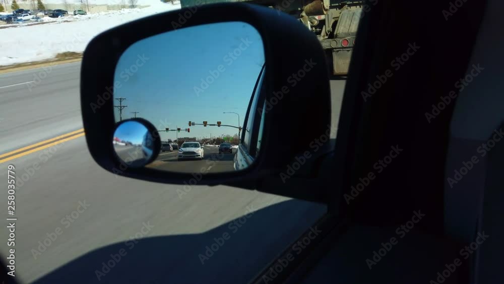 Driving on the Highway view from a Rearview mirror in the winter time. Driving on the Highway view from a Rearview mirror in the winter time.
