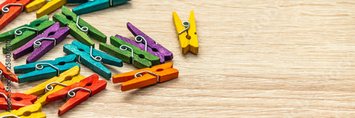 Colorful laundry clips on vintage wood background. Vintage background. Lots of colored pegs. Many different colored clothes pegs close up. Lots of clothespins.