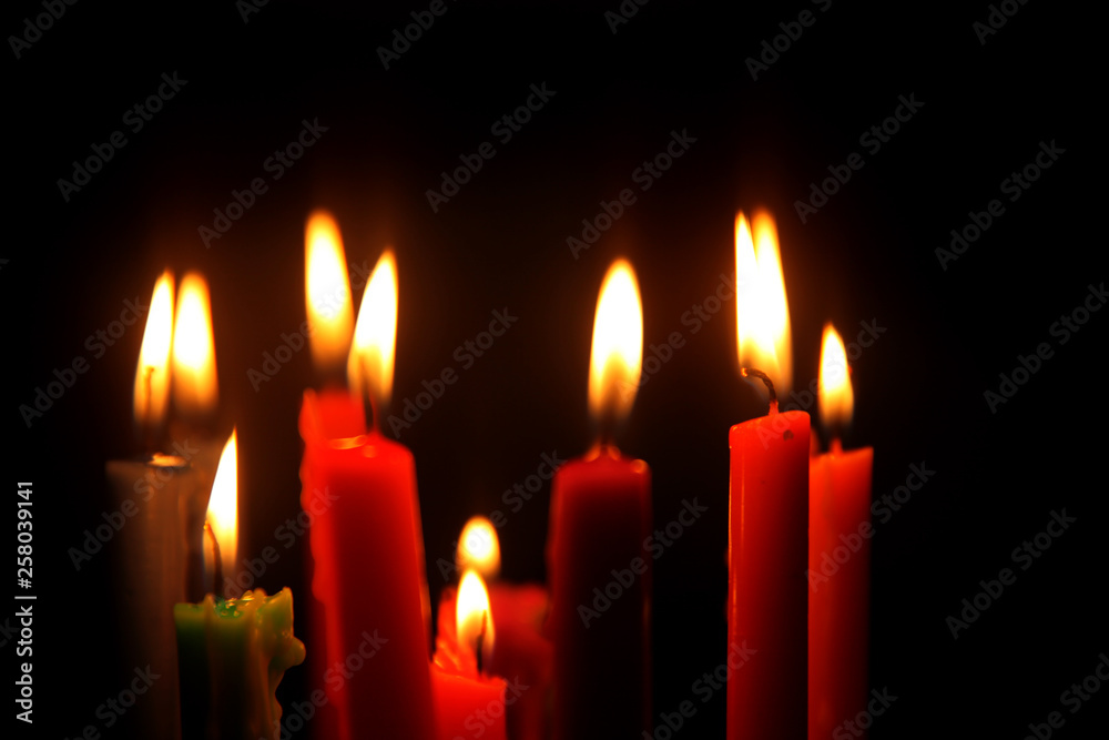 Colored candles burning in the dark Colored candles burning in the dark