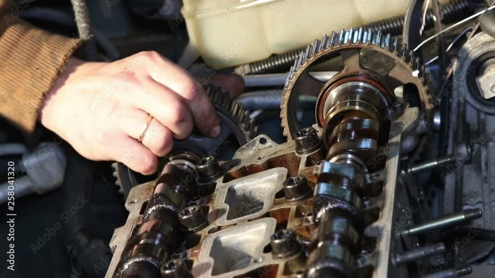 Mechanic repairs the car engine. Mechanic repairs the car engine.