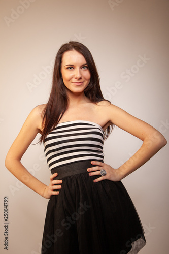 Beautiful brunette girl posing for photo at the studio