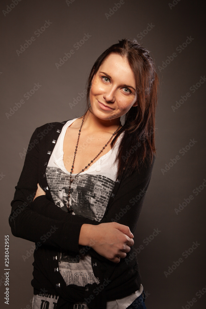 Fototapeta premium Beautiful brunette girl posing for photo at the studio
