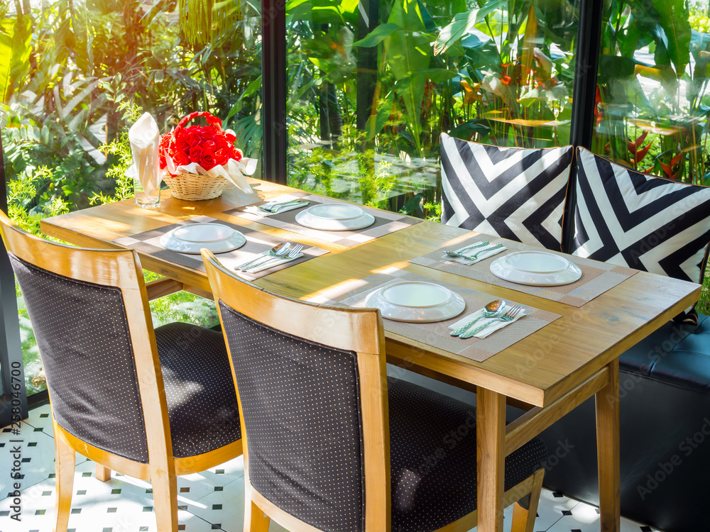 Dining table set in restaurant with romantic sunshine