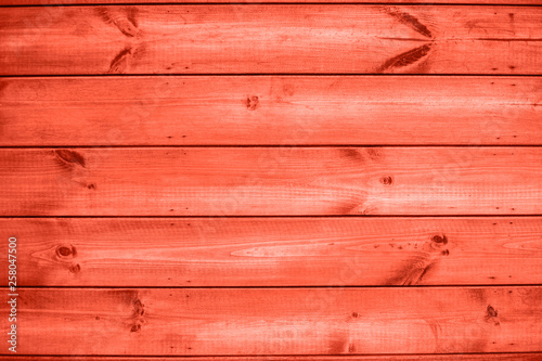 Wooden plank coral colour wall background outdoors.