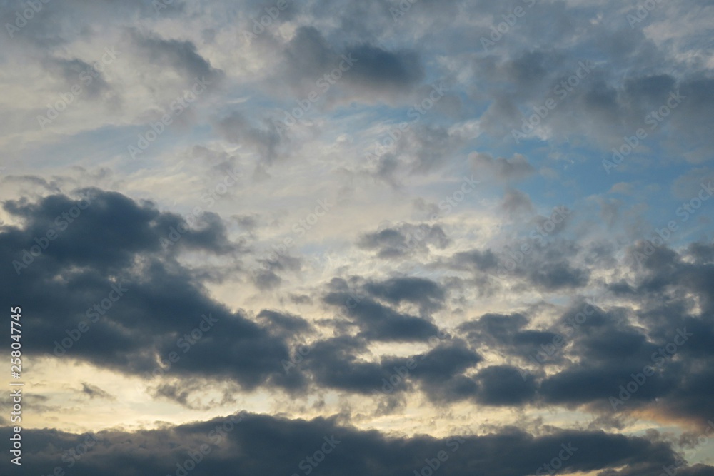 Beautiful yellow sunset with black dramatic clouds on horizon Beautiful yellow sunset with black dramatic clouds on horizon