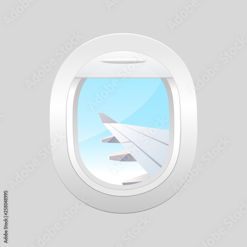 View from airplane. Window plane. Airplane windows with cloudy blue sky outside.