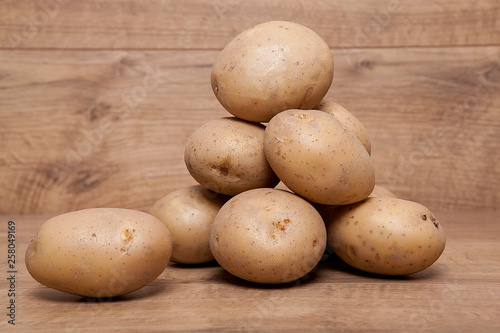 Potatoes on the wooden table.