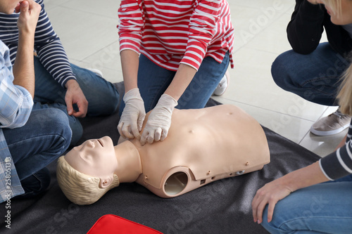 Tablou pe pânză People learning to perform CPR at first aid training course