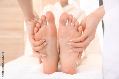 Young woman receiving feet massage in spa salon © Pixel-Shot