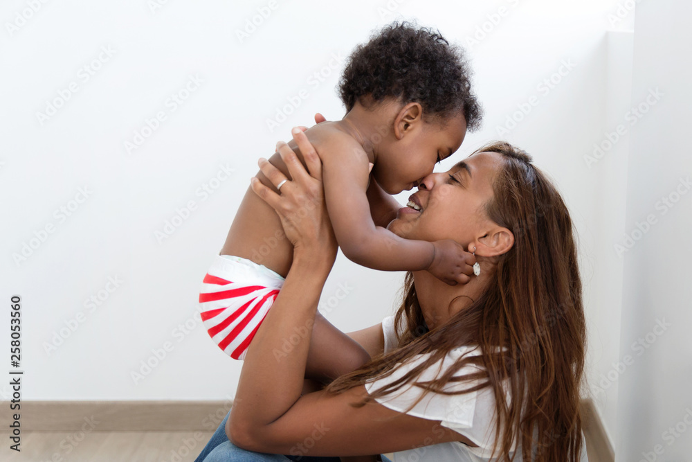Mother nuzzling her baby boy