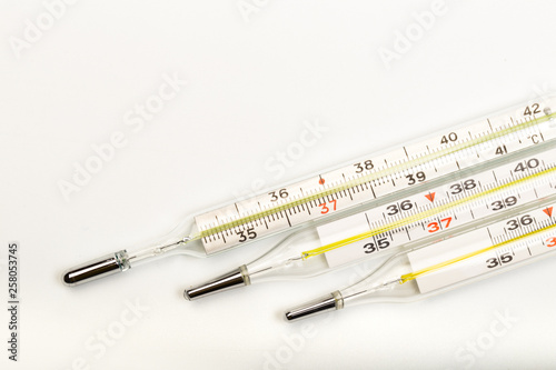 mercury thermometers on white background close up view