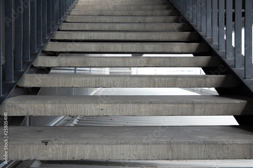 Fototapeta Naklejka Na Ścianę i Meble -  Empty concrete staircase with black steel handrail.