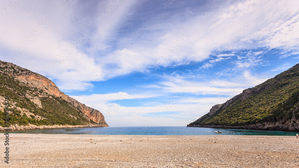 Beautiful Greek sand beach with cliffs