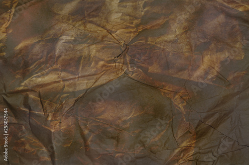 Texture of crumpled recycled brown paper. Brown tones.