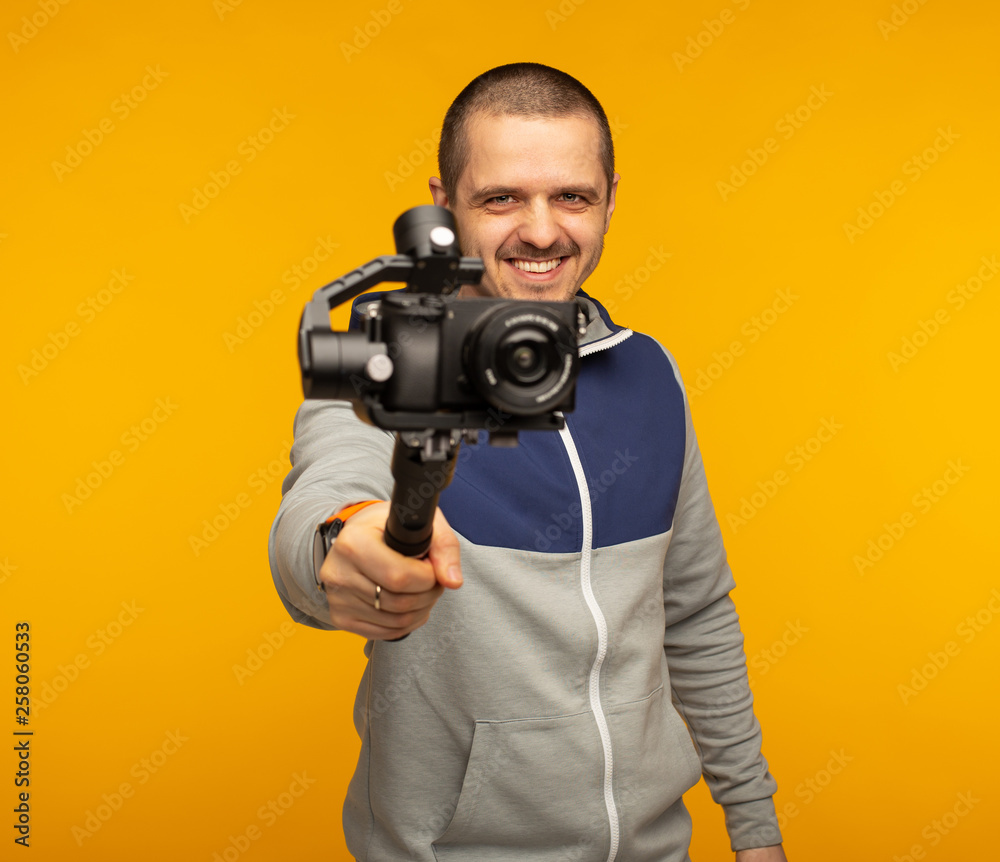 Videographer or blogger man pointing camera with gimbal Videographer or blogger man pointing camera with gimbal