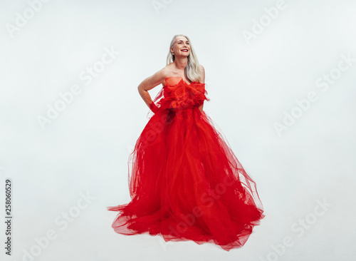 Beautiful senior woman in a red evening gown
