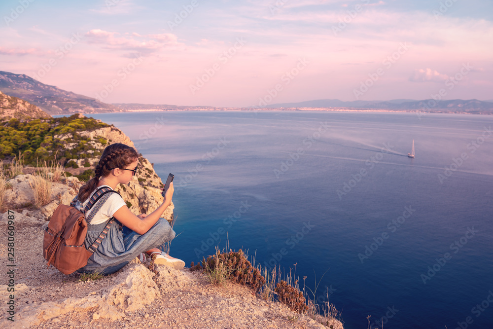 Young beautiful girl traveling along the coast of the Mediterranean Sea.