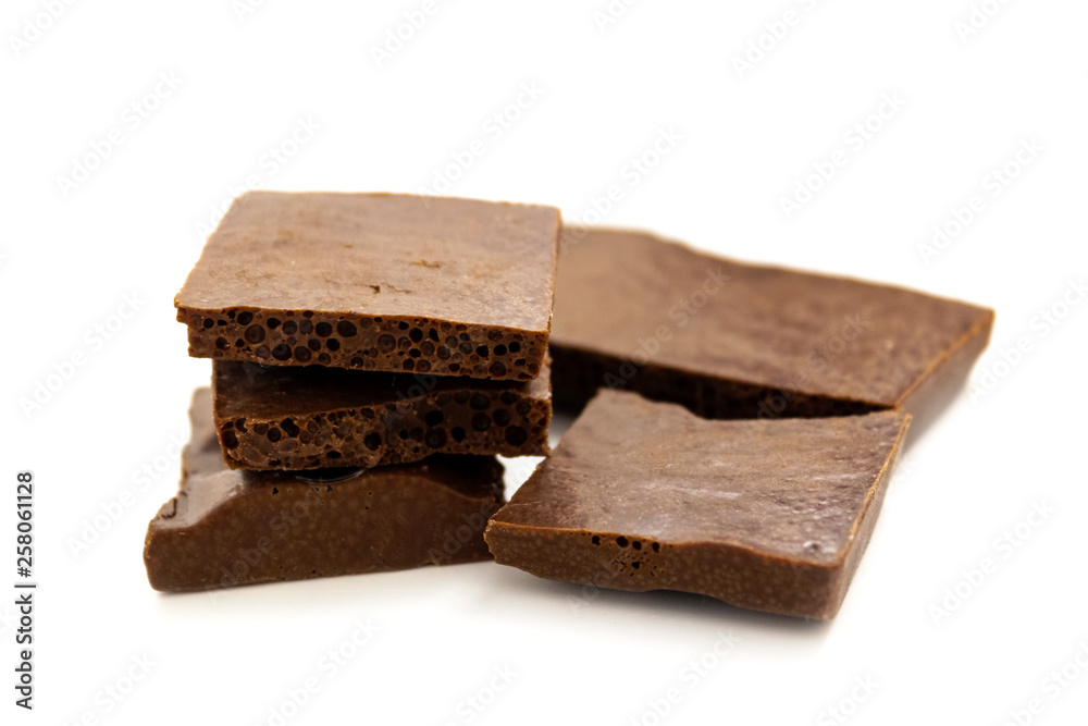 pieces of porous chocolate on a white background, isolate pieces of porous chocolate on a white background, isolate